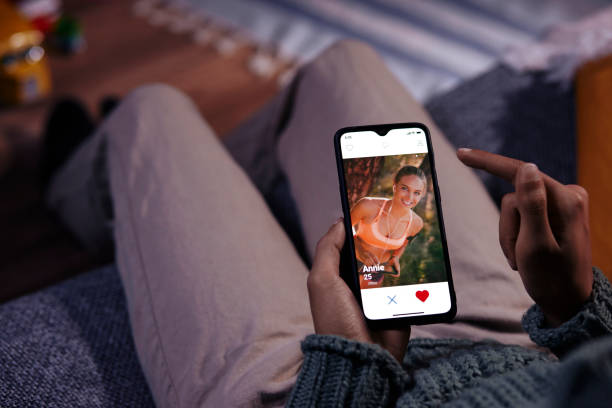 istock Man using mobile phone dating app at home 1296350504