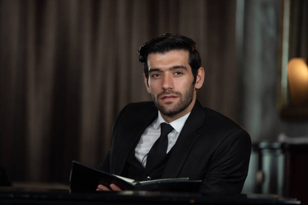 Portrait of young handsome confident businessman holding a notebook, Business concept