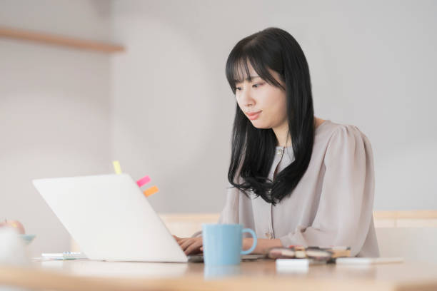 istock Asian woman working from home 1296352442
