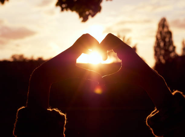 istock Hands in shape of love heart 1296352847