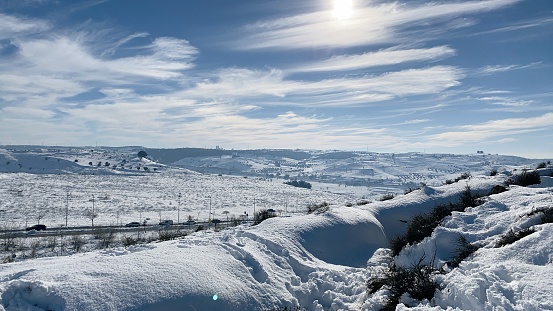 Winter scene from a hill in Arganda after the snowstorm in January 2021. Sky with long clouds