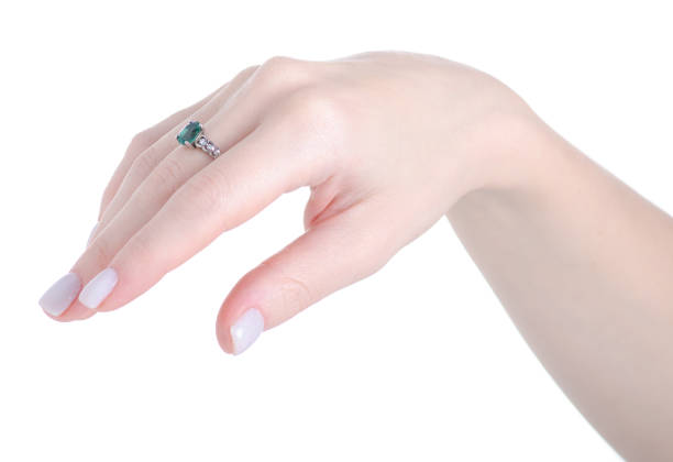 istock Female hand with silver ring green stone of finger 1296353267