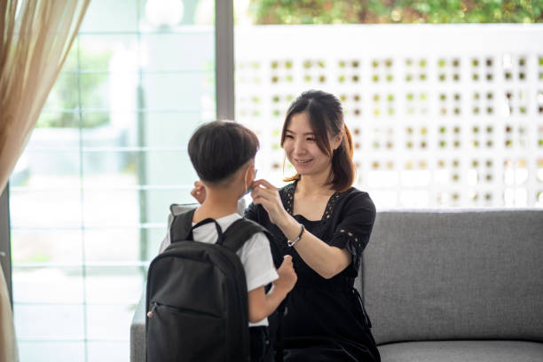 istock Asian mother help her son wearing face mask for protection Coronavirus outbreak 1296353942