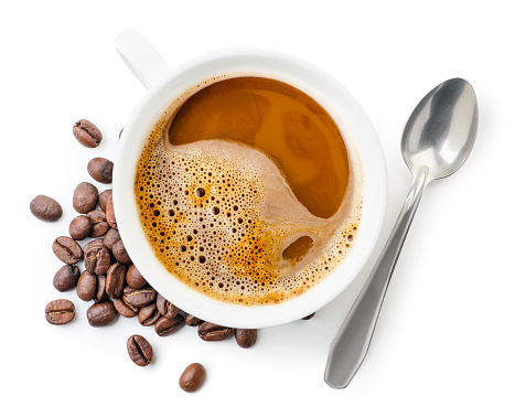 Cup with coffee, coffee beans and spoon close up on white background, isolated. Top view