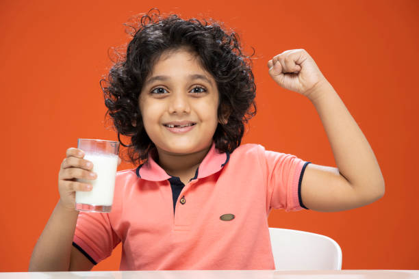 istock child boy drinking milk- stock photo 1296359066