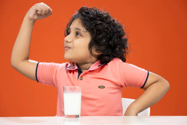 istock child boy drinking milk- stock photo 1296359113