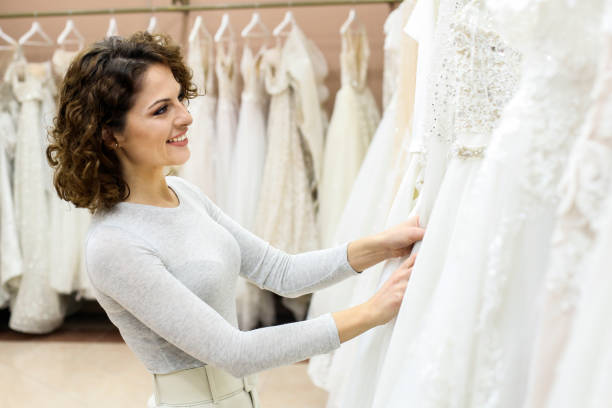 istock Young woman looking at wedding dresses 1296360569
