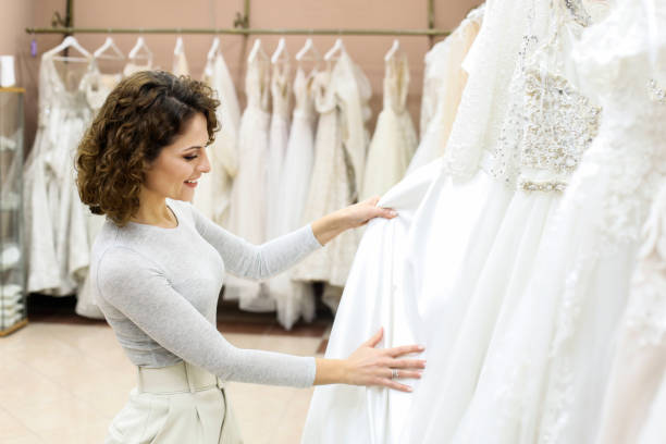 istock Bride looking at wedding dresses in a bridal shop 1296361175