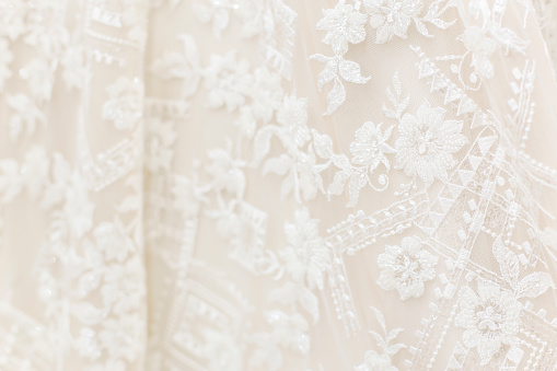 Lace textile abstract detail on a wedding dress perfect for backgrounds.