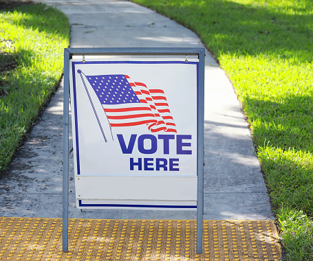 VOTE HERE SIGN placed on the walkway to a neighborhood polling place, as seen on election day in Fort Lauderdale, Florida, USA.