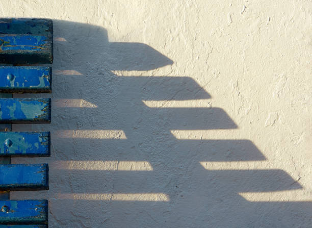 istock old wooden bench against white wall with shadow 1296361889