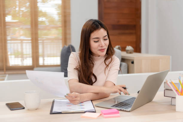 istock Work from home concept, a happy smiling beautiful Asian women Working at desktop computer laptop It is a new normal lifestyle of the online era. 1296361923