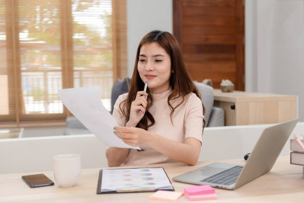 istock Work from home concept, a happy smiling beautiful Asian women Working at desktop computer laptop It is a new normal lifestyle of the online era. 1296361957