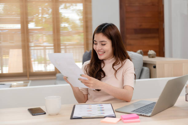 istock Work from home concept, a happy smiling beautiful Asian women Working at desktop computer laptop It is a new normal lifestyle of the online era. 1296362212