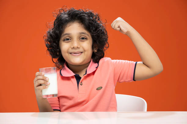 istock child boy drinking milk- stock photo 1296363649