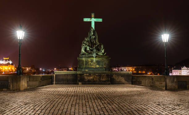 Prague, Czech Republic-January 31, 2019. Night scene. Statue of the Lamentation of Christ on the south side of the Charles bridge, depicts Mary Magdalene and the Virgin Mary mourning the dead Christ.