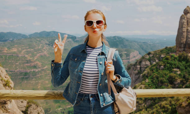 istock Travel image young woman posing on a mountain Montserrat background 1296364407