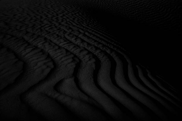 istock Black and white dark texture of desert sand dunes 1296366006