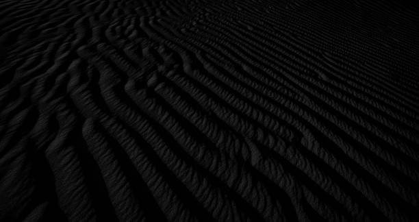 istock Black and white dark texture of desert sand dunes 1296366058