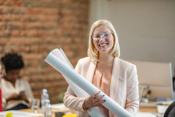 istock Portrait of architect woman with blueprints protect 1296369312