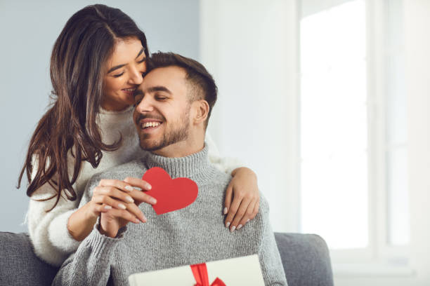 Valentine's day. Couple gives heart to the Valentine's Day in the room. Valentine's day. Couple gives heart to the Valentine's Day in the room. valentines day stock pictures, royalty-free photos & images