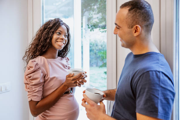 istock Lovely couple enjoy a coffee at home 1296370815