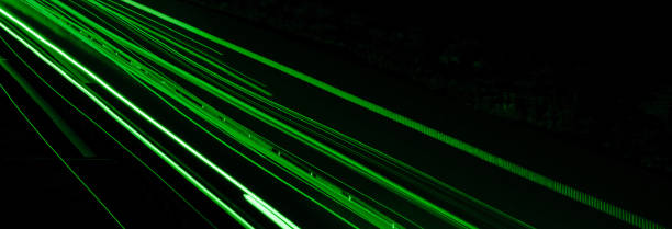 istock green car lights at night. long exposure 1296372011