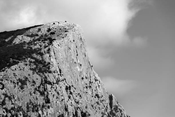 istock Summer high rocks with forest and cloudy sky 1296373204