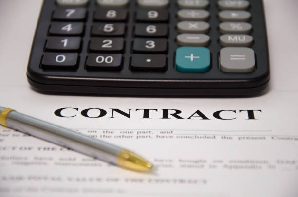istock contract pen and calculator lie on a white background. sign contract. 1296373253
