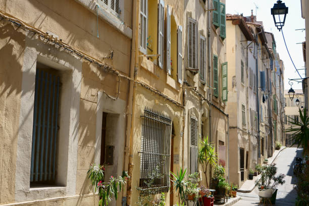 Narrow street with old houses in Marseille, France Narrow street with old houses in Marseille, France marseille panier stock pictures, royalty-free photos & images