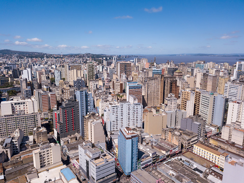 Drone aerial view of buildings skyline of Porto Alegre city, Rio Grande do Sul state, Brazil. Beautiful sunny summer day with blue sky. Concept of urban, architecture, cityscape, landmark, downtown.