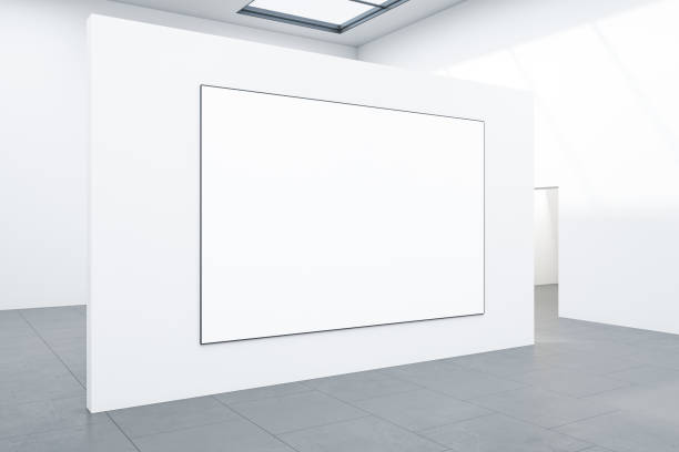 istock Exhibition room with blank poster on white wall. 1296374945