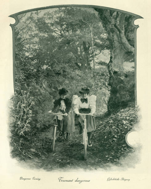 istock Young women cycling down forest trail, Victorian, 19th Century 1296375817