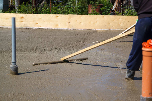 istock worker in rubber boots stands in uncluttered cement and leveling 1296376913