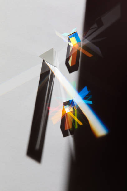 istock Glass geometric figures prisms with light diffraction of spectrum colors and complex reflection with trendy light and hard shadows on a white background 1296377546
