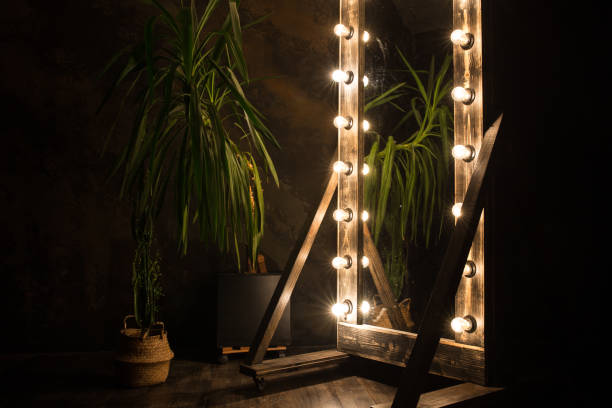 istock Toilet mirror stands on a wooden floor with light bulbs for lighting 1296378077