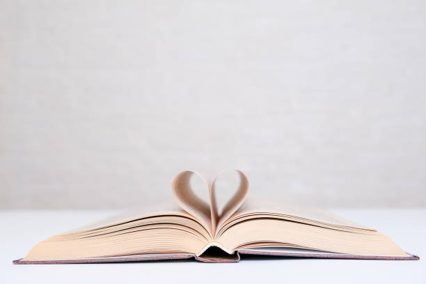 istock Love books and reading concept, book pages folded into a heart shape with copy space 1296379717