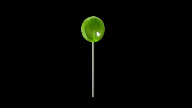Kiwi lollipop on black background