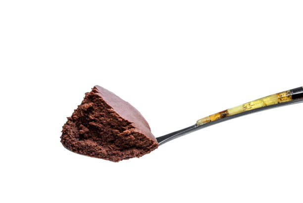 Melted dark chocolate spoon detail isolated