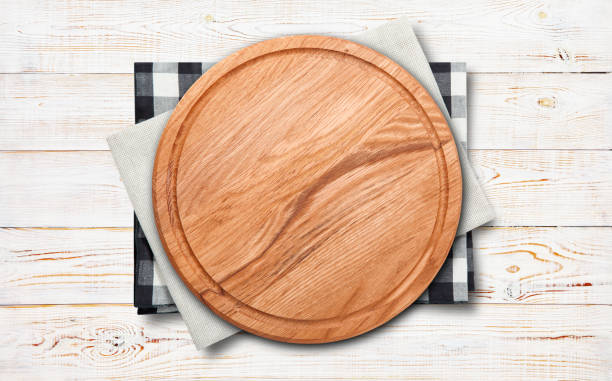 istock Empty vintage pizza board and napkin on planks. 1296381907
