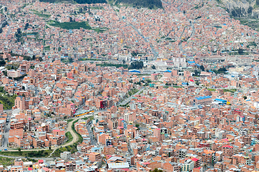 City town center of La Paz with skyscrapers and lots of living houses scattered on the hills, Bolivia.