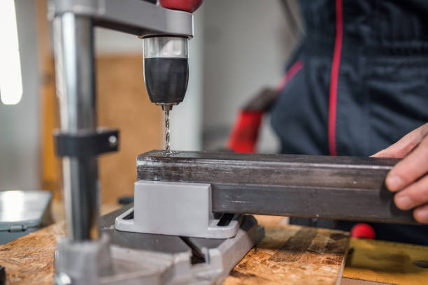 istock Metal worker drilling metal in workshop 1296385198