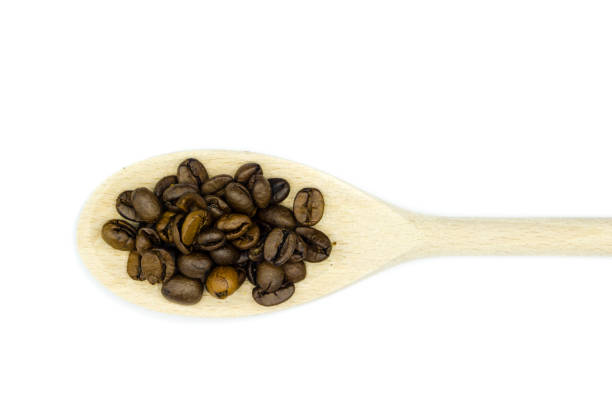 istock roasted coffee beans on wooden spoon isolated on white background top view 1296388724