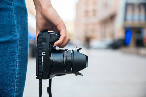 istock woman hand photo camera 1296389018
