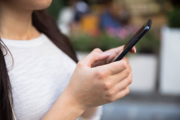 istock woman holding smart phone 1296389024