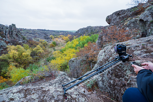 Camera on slider shots footage of beautiful hills covered with autumn trees in the Carpathians mountains