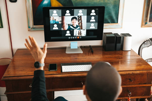 istock Man hosting a online call, waiting for users to connect. Live streaming video conference. 1296391351