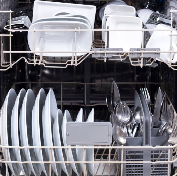 istock dishes in dish washer machine at the kitchen 1296392469