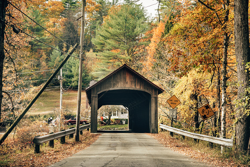 Colorful fall trees in the Adirondacks around Jay covered bridge in New York State in the autumn