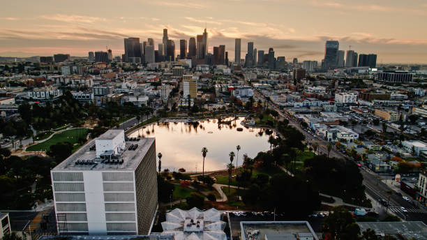 istock MacArthur Park At Sunrise with DTLA Skyline is Distance - Drone Shot 1296393599